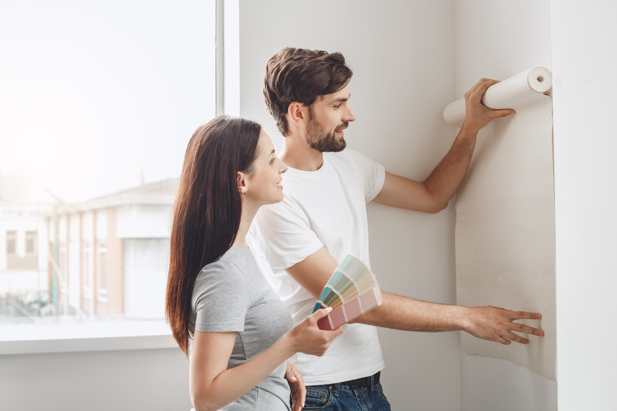 Wohnung richtig tapezieren Junges Paar tapeziert Wohnung