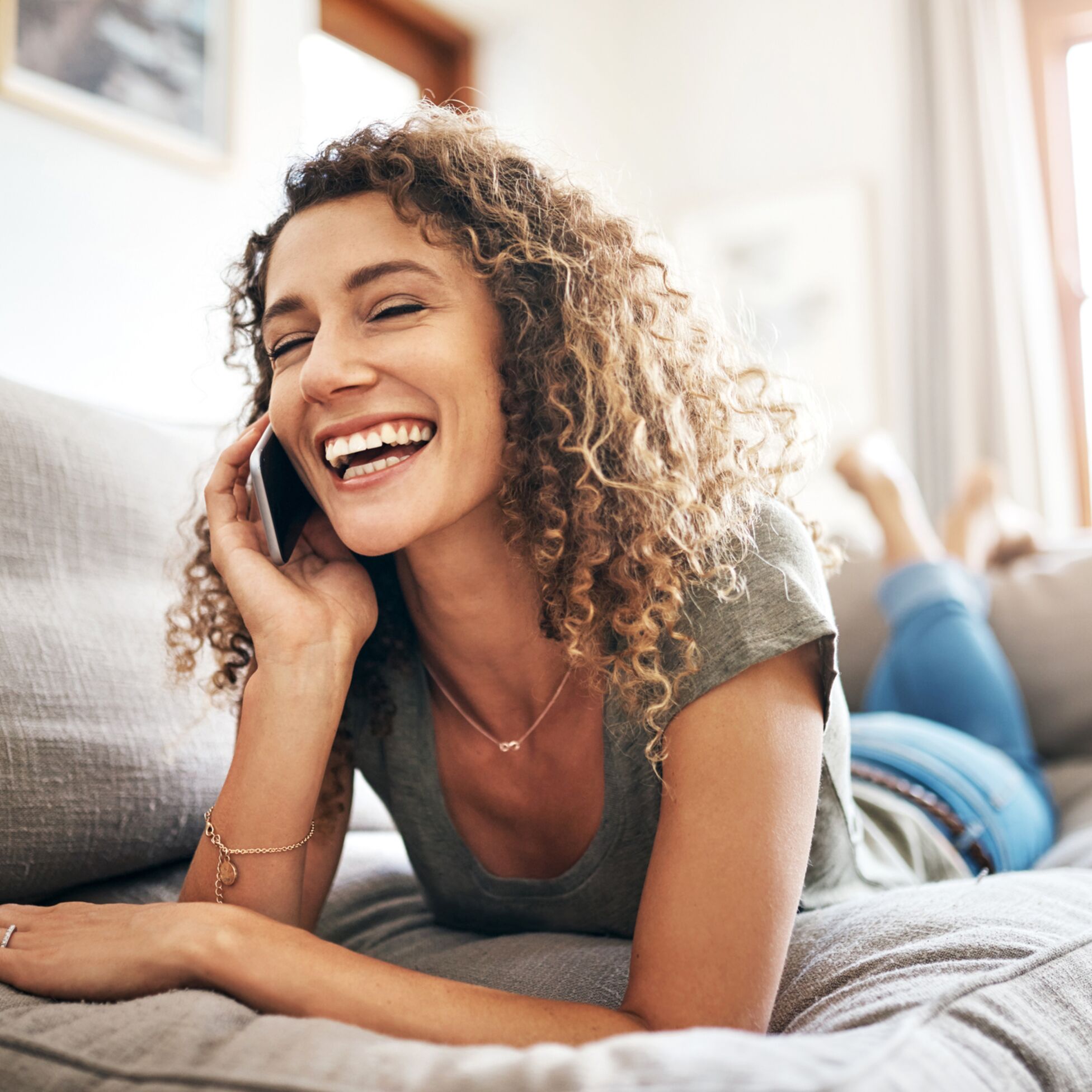 Frau mit Smartphone telefoniert glücklich